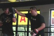 Lou Storiale holding mitts for a student