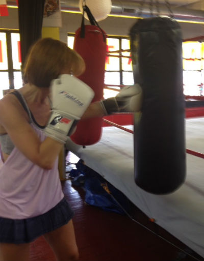 Woman training on the heavy bag