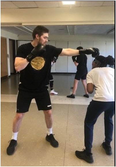A student learning to slip a jab from his partner